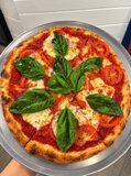 Margherita pizza with fresh basil and tomato