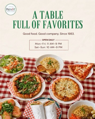 A table full of favorites: pizzas, pasta, salad and sandwiches