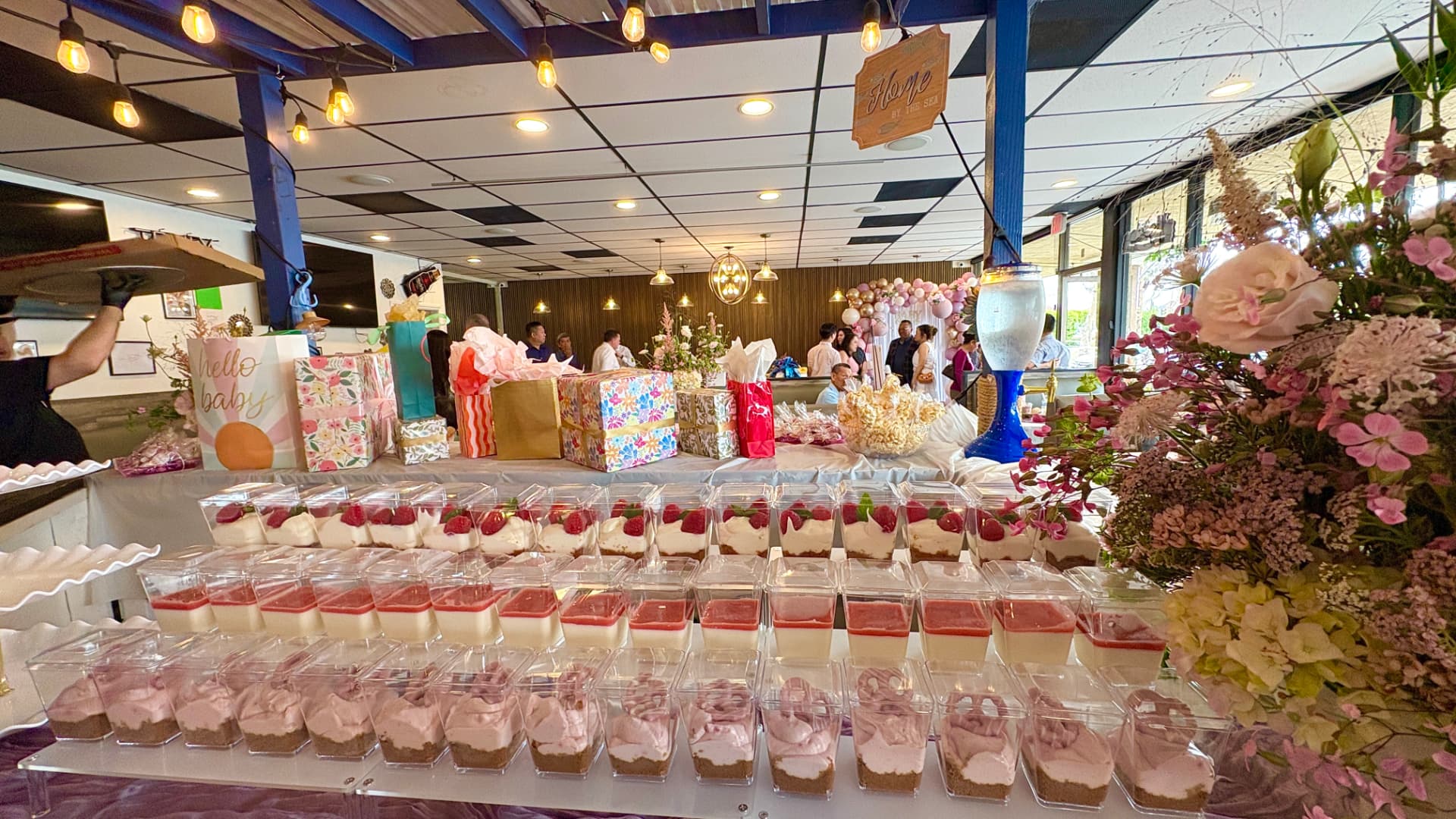 Baby shower dessert table and gifts in the dining room