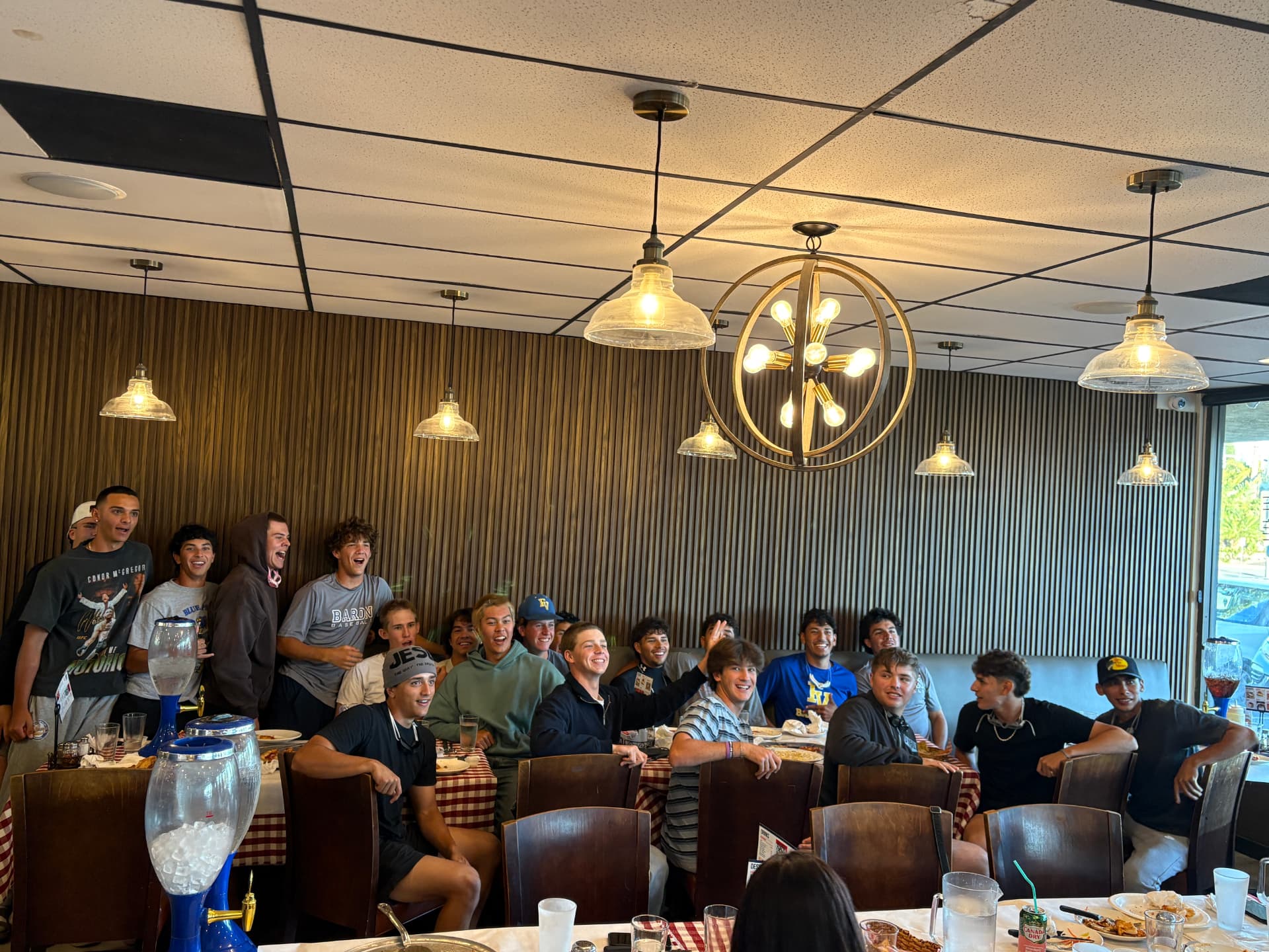 Baseball team celebrating together in the dining room